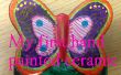 Kinderen bouwen - Hand een keramische vlinder kleuren